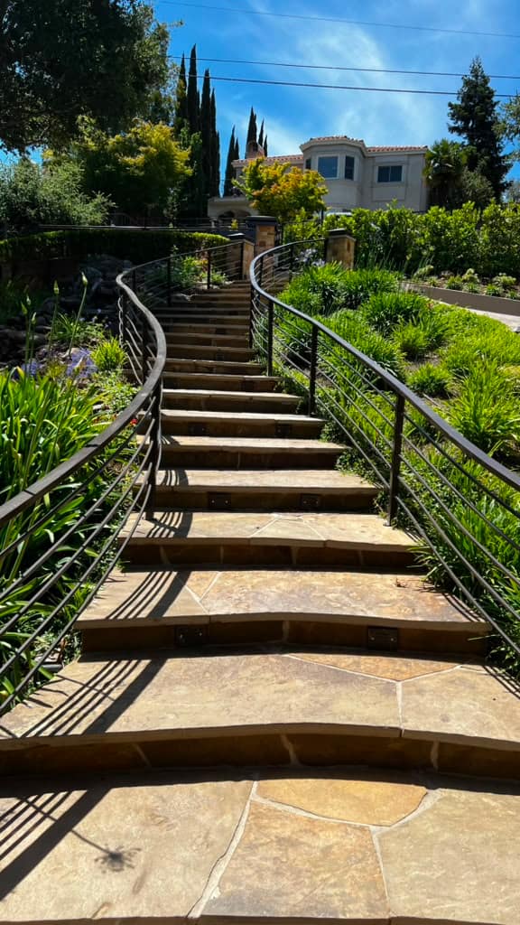 Ornamental fence engineered to follow a sloped hillside grade