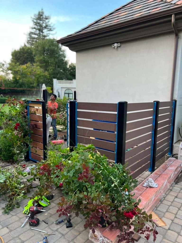 Modern horizontal wood-and-metal fence with blue posts
