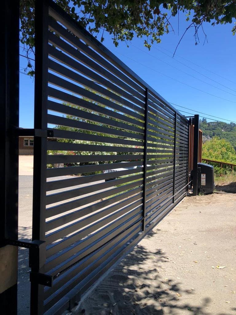 Modern custom automatic driveway gate with smart access at a Peninsula estate