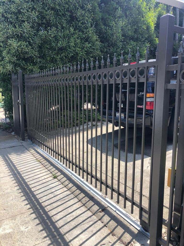 Custom ornamental steel driveway gate with a circle pattern design