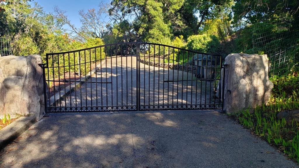 Automatic iron driveway gate on a long Contra Costa County estate driveway installed by NGL Automatic Gates