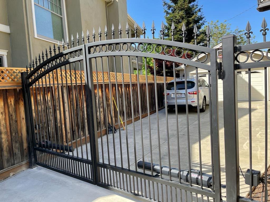 Ornamental iron automatic estate gate with finial tips at a Marin County property