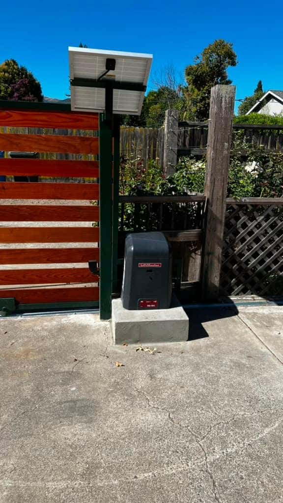 Redwood sliding driveway gate with slide-gate operator serviced by NGL Automatic Gates