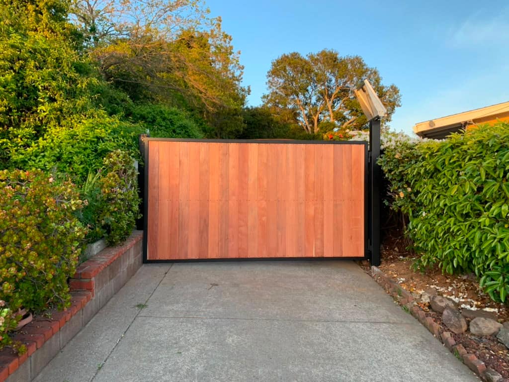 Sliding automatic gate along a long inland driveway with hedging in Contra Costa County