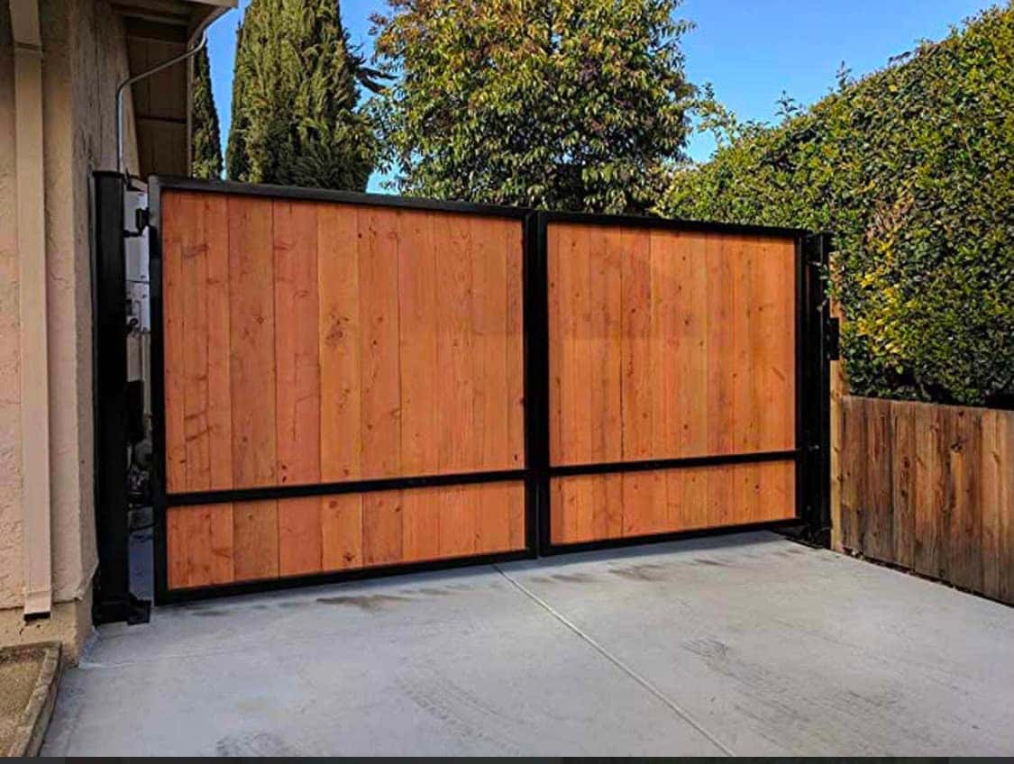 Redwood vertical-panel driveway gate for a tight lot